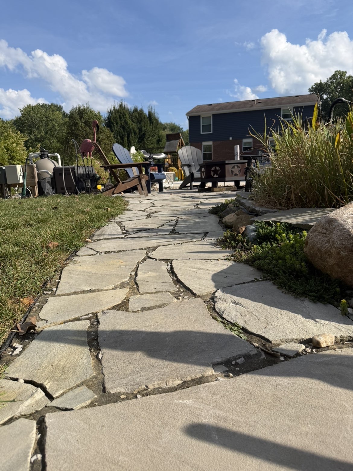 Natural flagstone walkway through a backyard